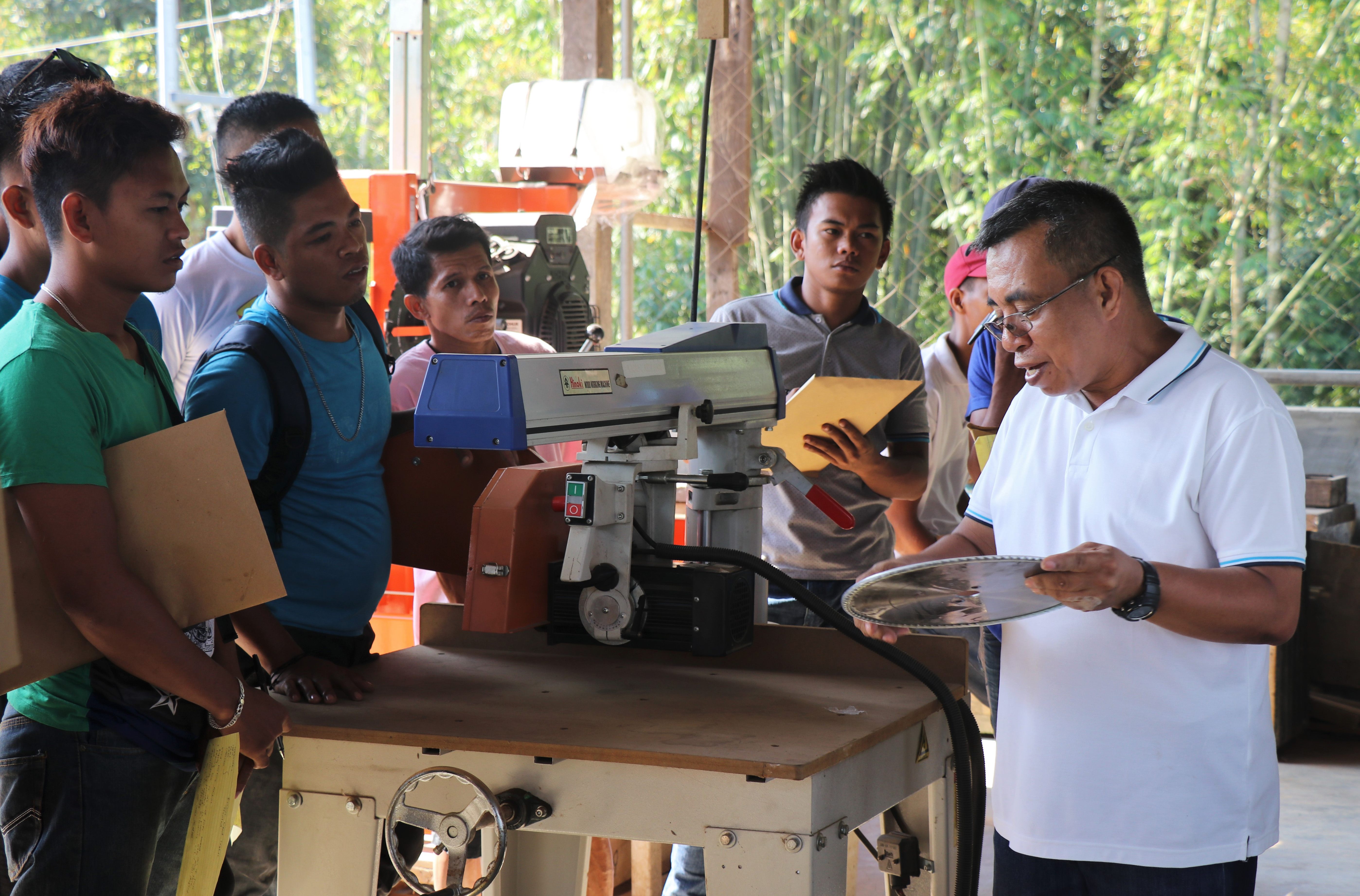 Engr. Revilleza discusses the parts of a basic woodworking machine.