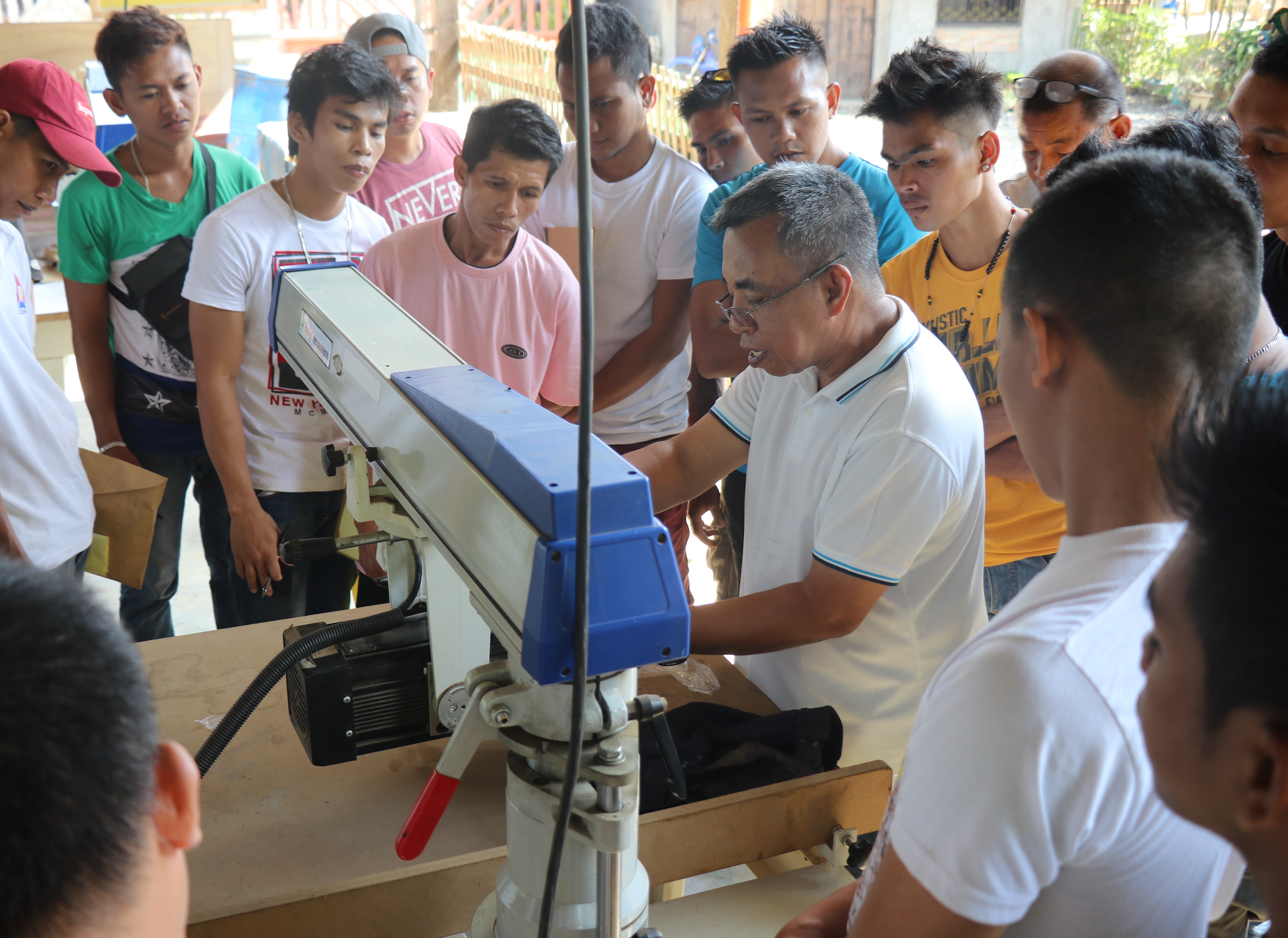 Engr. Revilleza demonstrates basic woodworking machine operation.