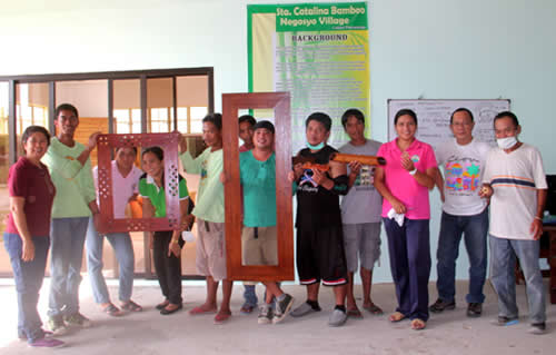 The participants pose with some of their finished materials during the closing program.