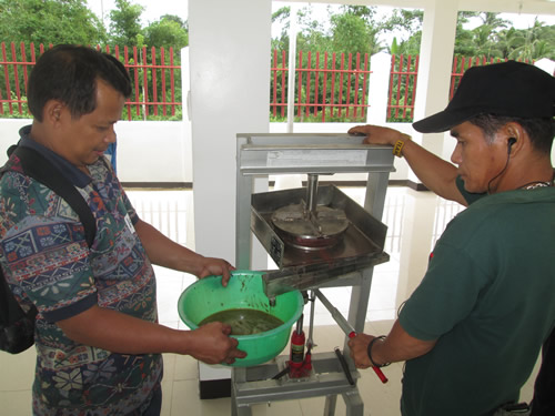 Members of the CNPGPA learn how to extract oil from the pili nut.