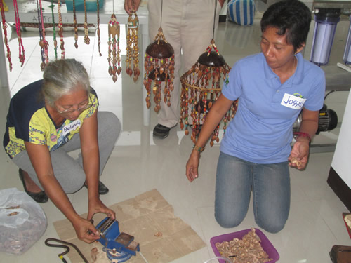 Members of the CNPGPA learn how to make handicraft items from the pili shell.