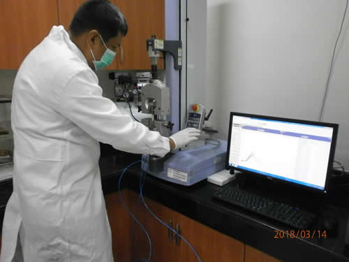 Mr. Freddie M. Ordinario conducts a test at the FPRDI Plywood Testing Laboratory.