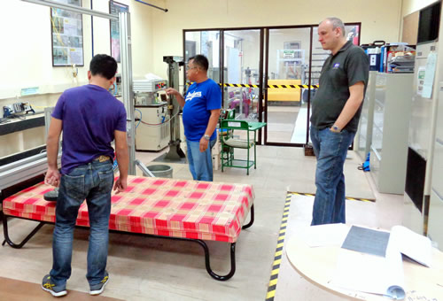 Mr. Bruce Lovell (right), a representative of the Furniture Industry Research Association (FIRA), evaluates the competence of DOST- Forest Products Research and Development Institute’s Furniture Testing Center (FFTC) staff in furniture test procedures.