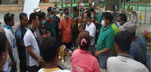 FPRDI personnel trains rice farmers.