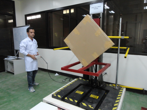 Engr. Edward Paul S. Marasigan performs the drop test on a furniture package.