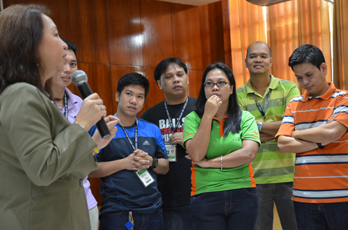 Resource person Dr. Ma. Luisa Agamata coaches a group of employees.