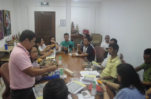 DOST-FPRDI’s Engr. Gil B. Dolotina (standing) demonstrates how to use the FPRDI digital wood moisture meter.